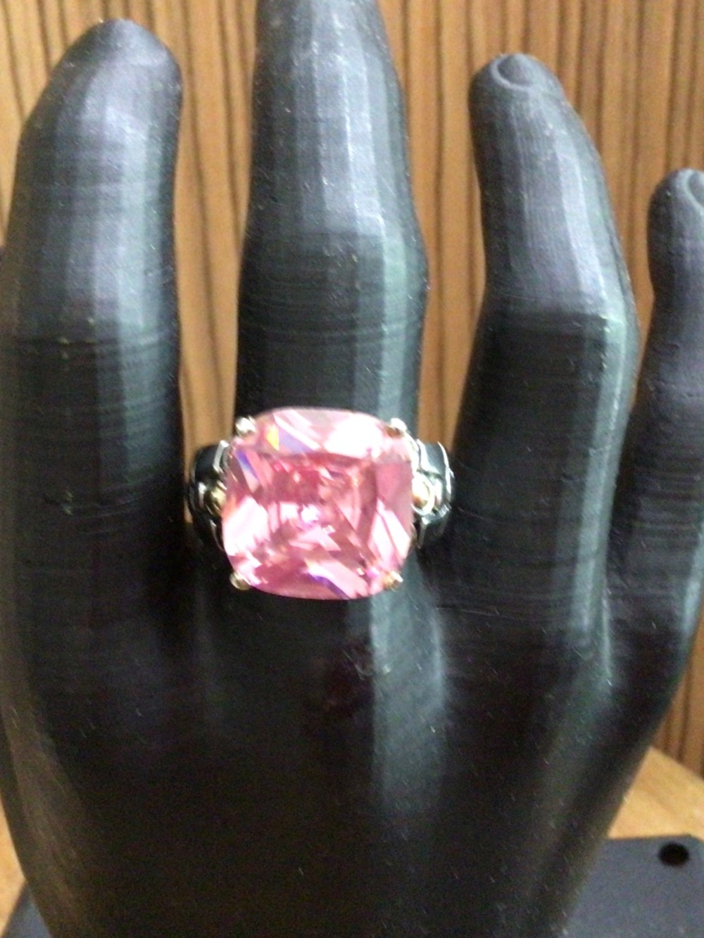 Pink rhinestone ring with Silvertone scrolling. Size 10.